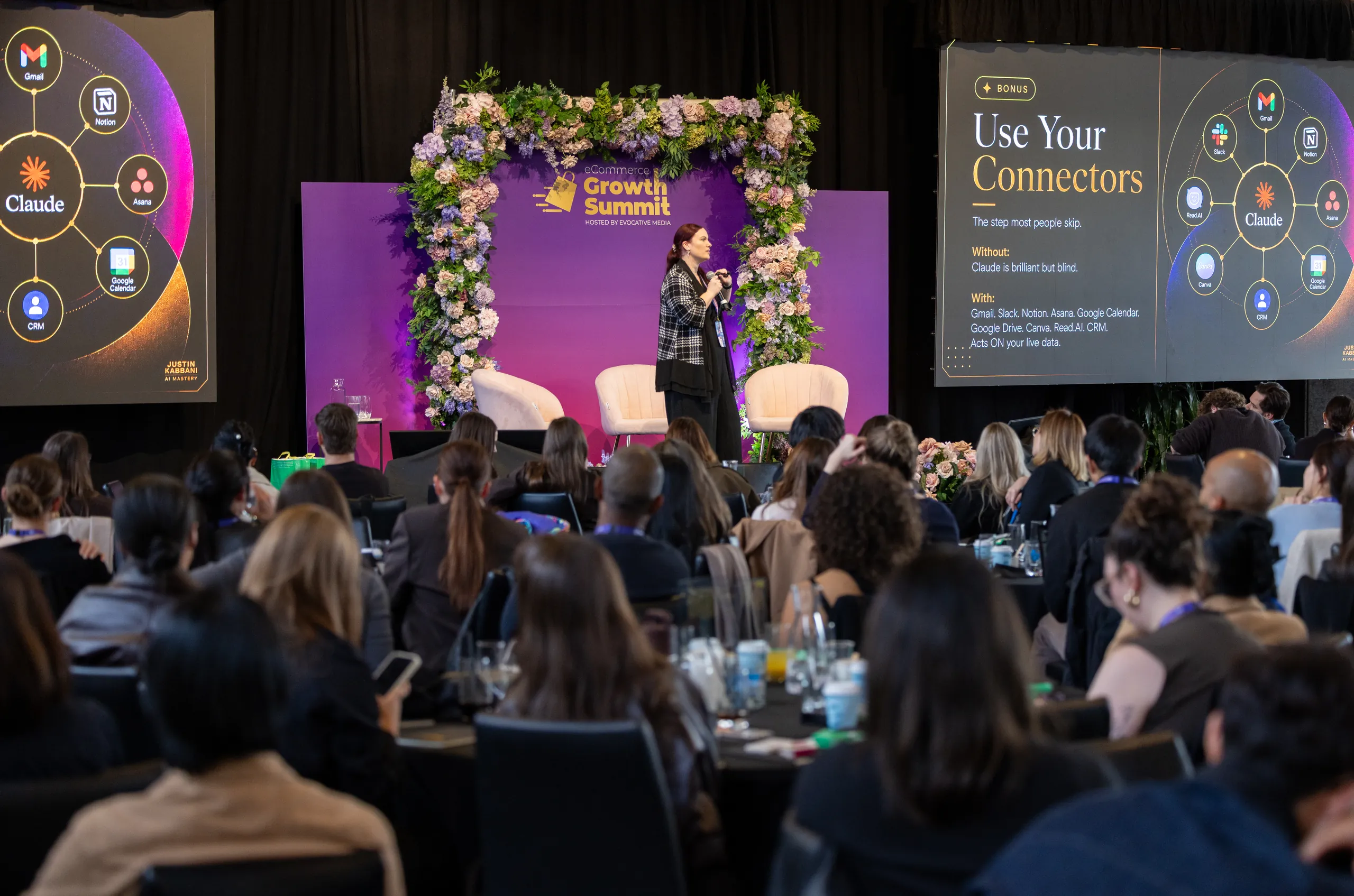 Jodee Bibaeff presenting to a full room at the eCommerce Growth Summit in Melbourne, flanked by Justin Kabbani AI Mastery slides