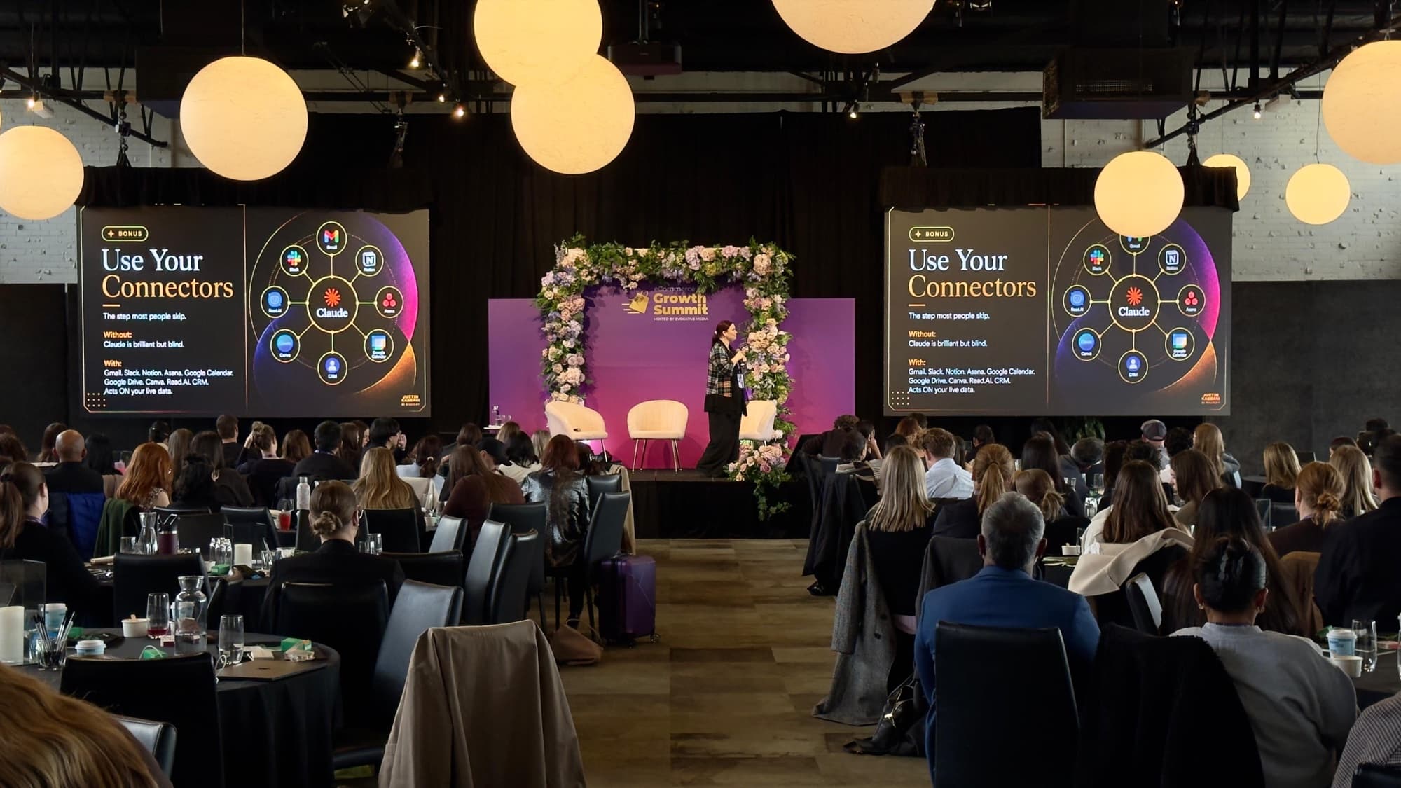 Jodee Bibaeff on stage at a summit, presenting AI strategy