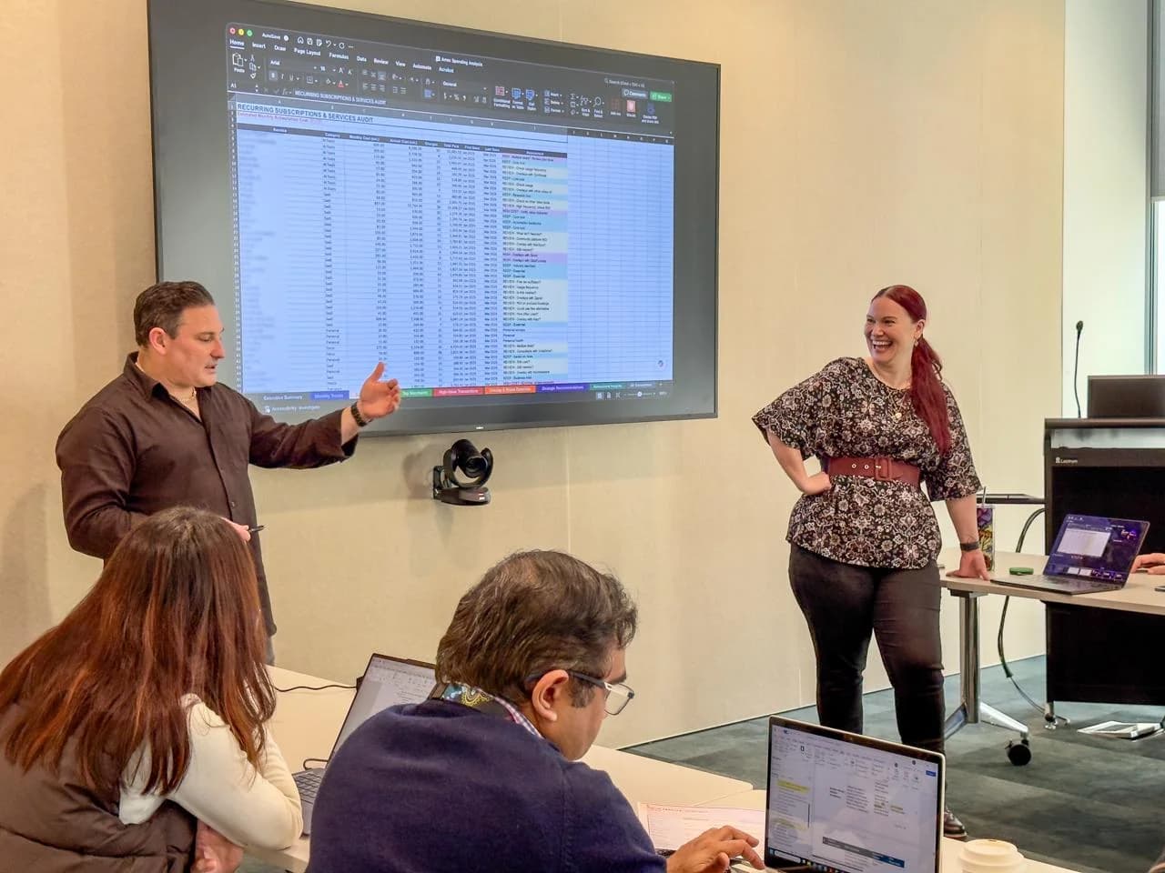 Jodee Bibaeff and Justin Kabbani co-presenting an AI session in a client boardroom